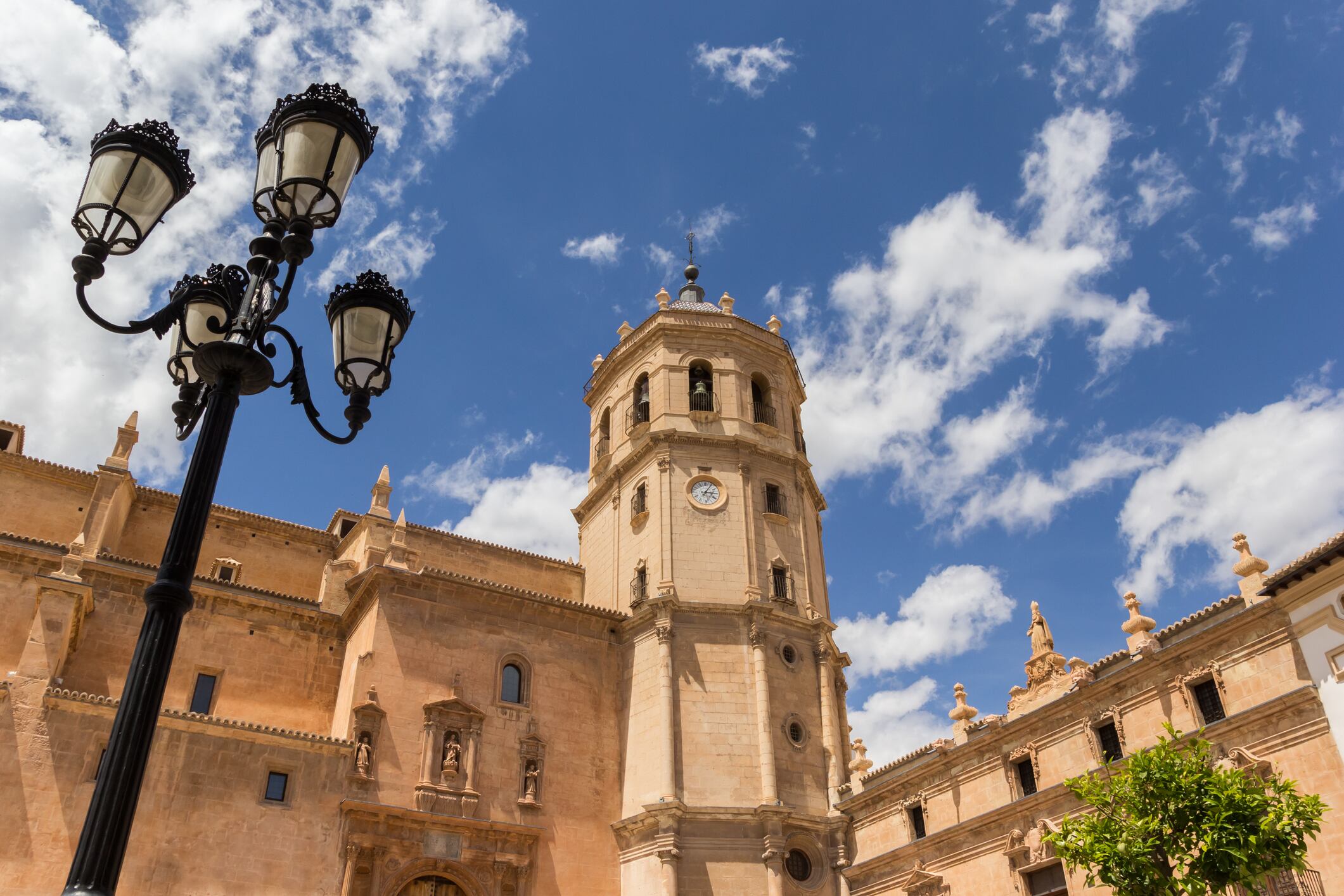 Street light and tower of the San Patricio church in Lorca, Spain