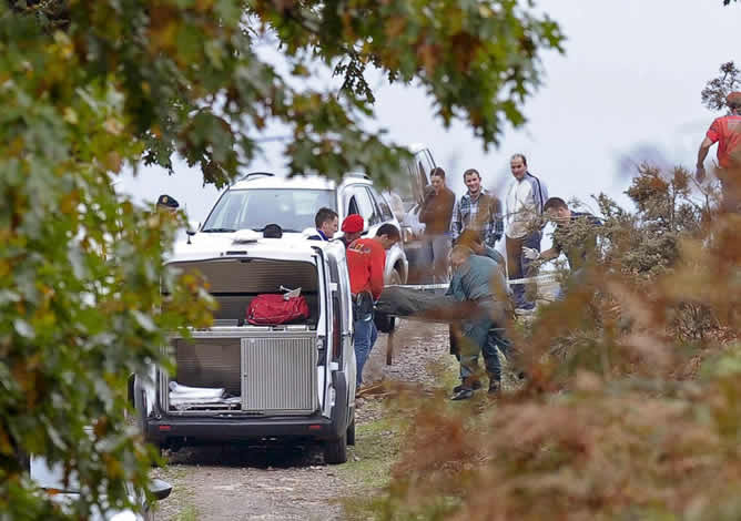 Agentes de la Policía Foral y de la Guardia Civil trasladan el cadáver de uno de los tres fallecidos en el valle navarro de Baztán. (EFE / Villar López)