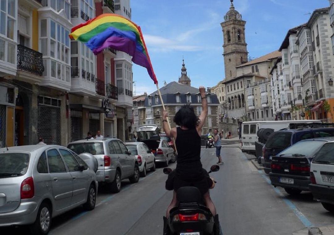 Una persona sostiene la bandera arcoíris