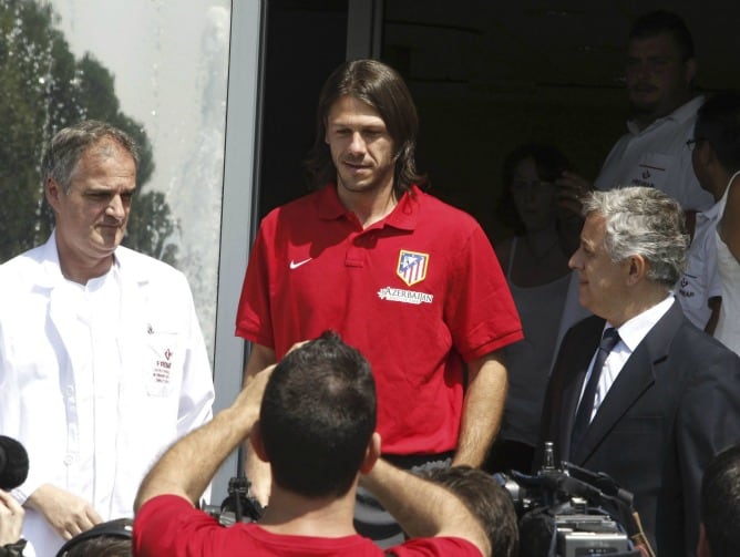 El defensa internacional argentino Martín Demichelis, junto al médico del Atlético de Madrid, José María Villalón, atiende a los medios de comunicación tras pasar hoy el reconocimiento médico en la clínica Fremap de Majadahonda, previo a la formalización 