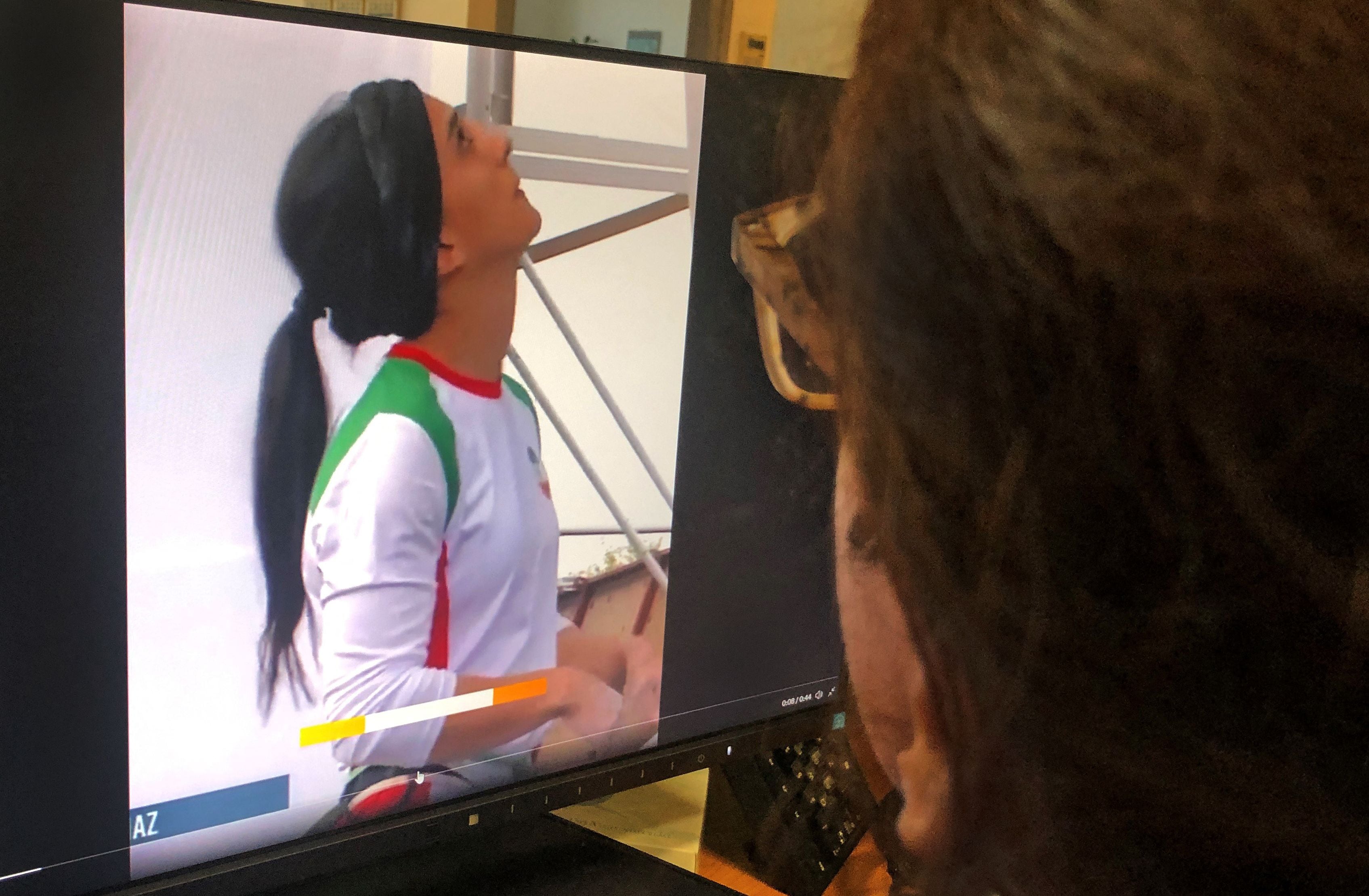 A woman looks at a screen displaying a video of an international climbing competition is Seoul, South Korea, during which Iranian climber Elnaz Rekabi competes without a hijab, in the Cypriot capital Nicosia on October 18, 2022. (Photo by AFP) (Photo by -/AFP via Getty Images)