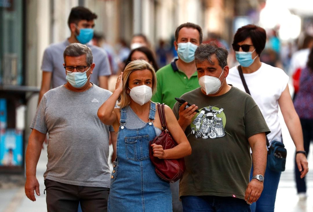 People wear protective face masks on the first day of their mandatory use for everyone over six in public spaces, when it is impossible to keep more than two meters social distancing, amid the outbreak of the coronavirus disease (COVID-19), in Ronda, Spain