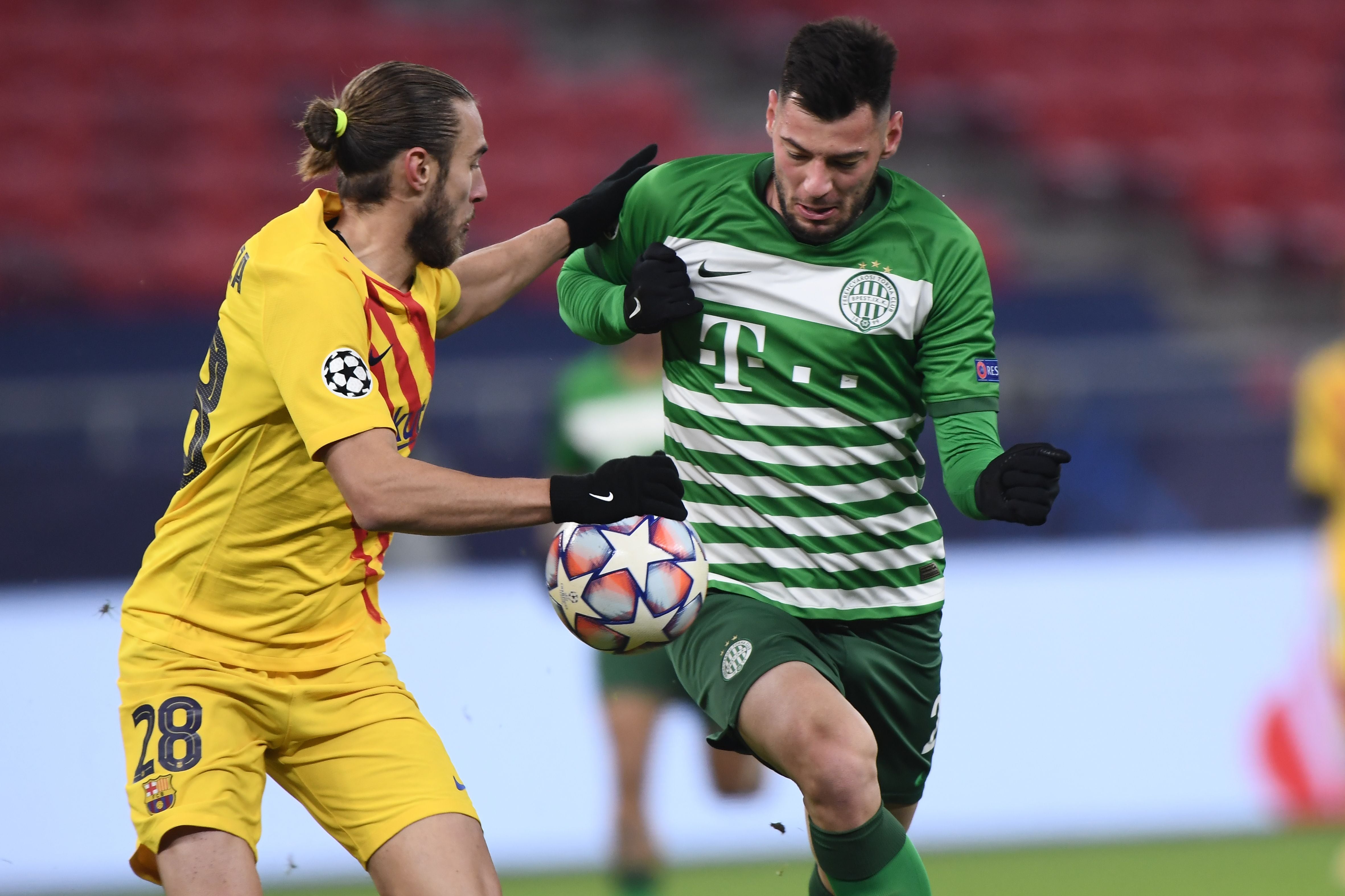 Barcelonas Spanish defender Oscar Mingueza and Ferencvaros Croatian forward Roko Baturina (R) vie for the ball during the UEFA Champions League football match Ferencvaros TC v FC Barcelona in Budapest on December 2, 2020. (Photo by Attila KISBENEDEK / AFP) (Photo by ATTILA KISBENEDEK/AFP via Getty Images)