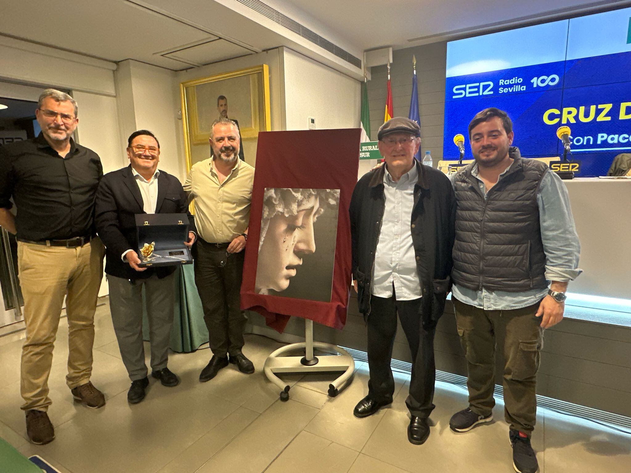 De izquierda a derecha junto a la fotografía de La Estrella, Alejandro Ruesga, Alejandro Marmolejo con la Rosa de Pasión salida de su taller, Paco García, el maestro Manolo Ruesga y José Manuel Peña