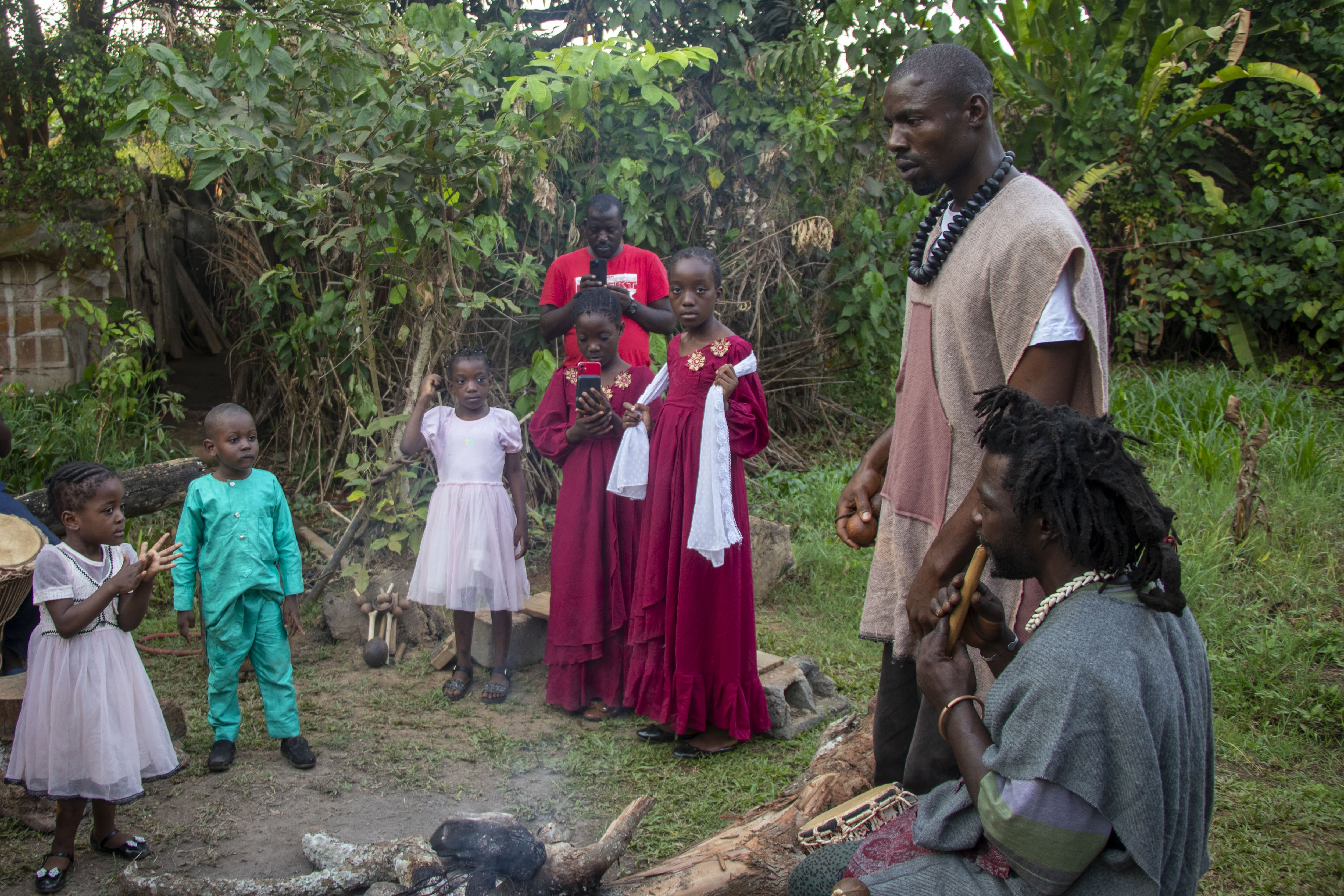 YAOUNDE, CAMEROON - JANUARY 24: Storytellers tell stories to children by an extinguished fire in Yaounde, Cameroon on January 24, 2025. Storytellers, who convey the cultural heritage, moral values and history of communities orally, entertain the public and undertake the task of raising social awareness. Respected storytellers in Cameroon not only tell stories but also share their wisdom and offer solutions to social problems. (Photo by Ahmet Emin Dönmez/Anadolu via Getty Images)