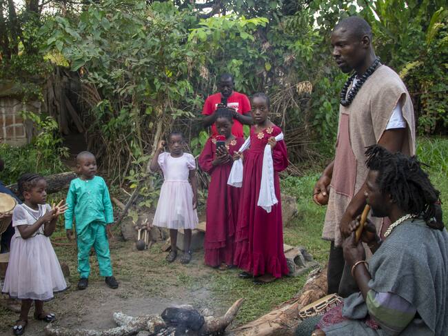 YAOUNDE, CAMEROON - JANUARY 24: Storytellers tell stories to children by an extinguished fire in Yaounde, Cameroon on January 24, 2025. Storytellers, who convey the cultural heritage, moral values and history of communities orally, entertain the public and undertake the task of raising social awareness. Respected storytellers in Cameroon not only tell stories but also share their wisdom and offer solutions to social problems. (Photo by Ahmet Emin Dönmez/Anadolu via Getty Images)