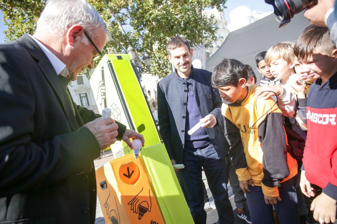 El alcalde Joan Ribó recicla una bombilla ante la presencia de alumnos del Colegio Jaume I de València