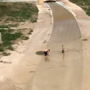 Dos personas se bañan en el cauce del río Guadalentín en pleno aviso amarillo de tormentas