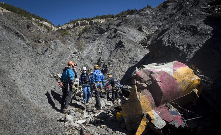 Rescue workers and investigators, seen in this picture made available to the media by the French Interior Ministry April 1, 2015, work near debris from wreckage at the crash site of a Germanwings Airbus A320, near Seyne-les-Alpes. The German pilot, Andrea