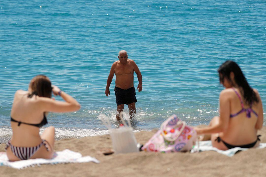 People enjoy on La Malagueta beach as some Spanish provinces are allowed 