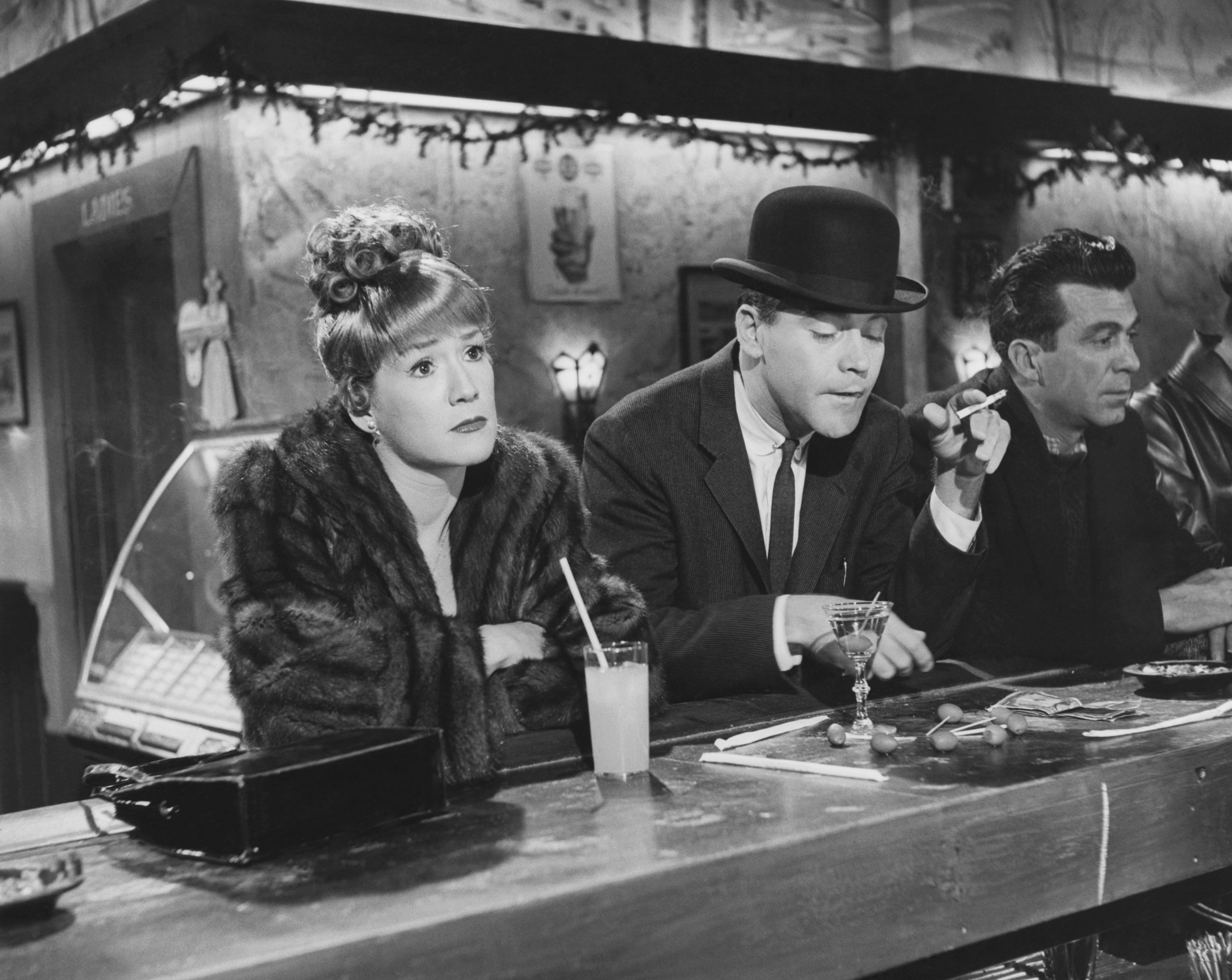 C.C. Baxter (Jack Lemmon) sits with Margie MacDougall (Hope Holiday) while drinking martinis at a bar in the 1960 comedy The Apartment.