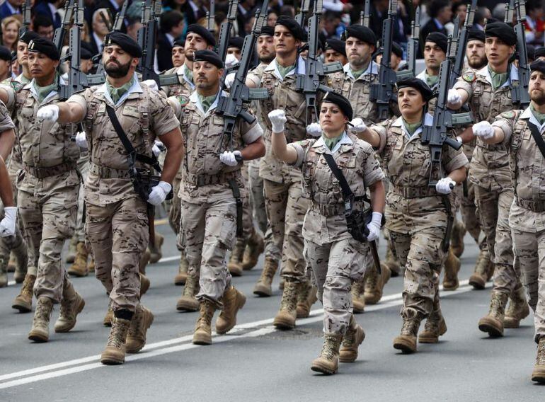 Hombres y mujeres militares desfilan durante el Día de las Fuerzas Armadas.