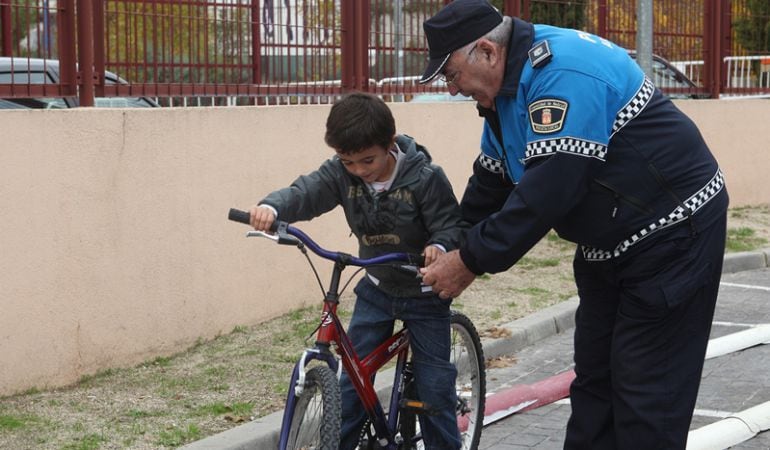 Un policía ayuda a un niño en Alcobendas