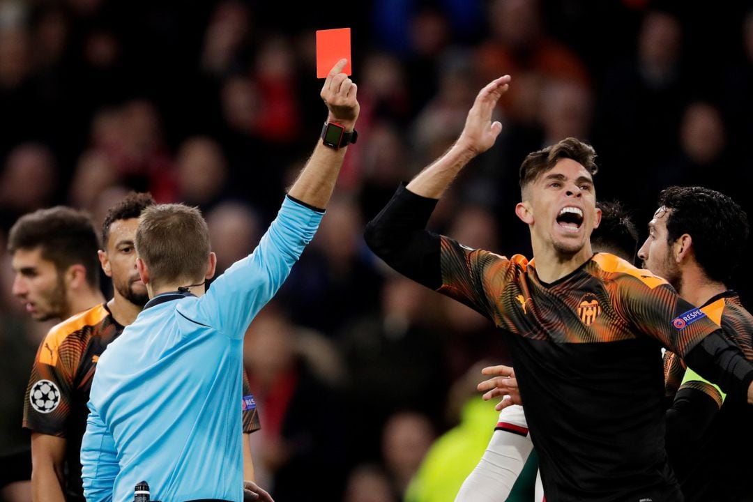 Gabriel Paulista of Valencia, receives a red card from referee Clement Turpin during the UEFA Champions League 