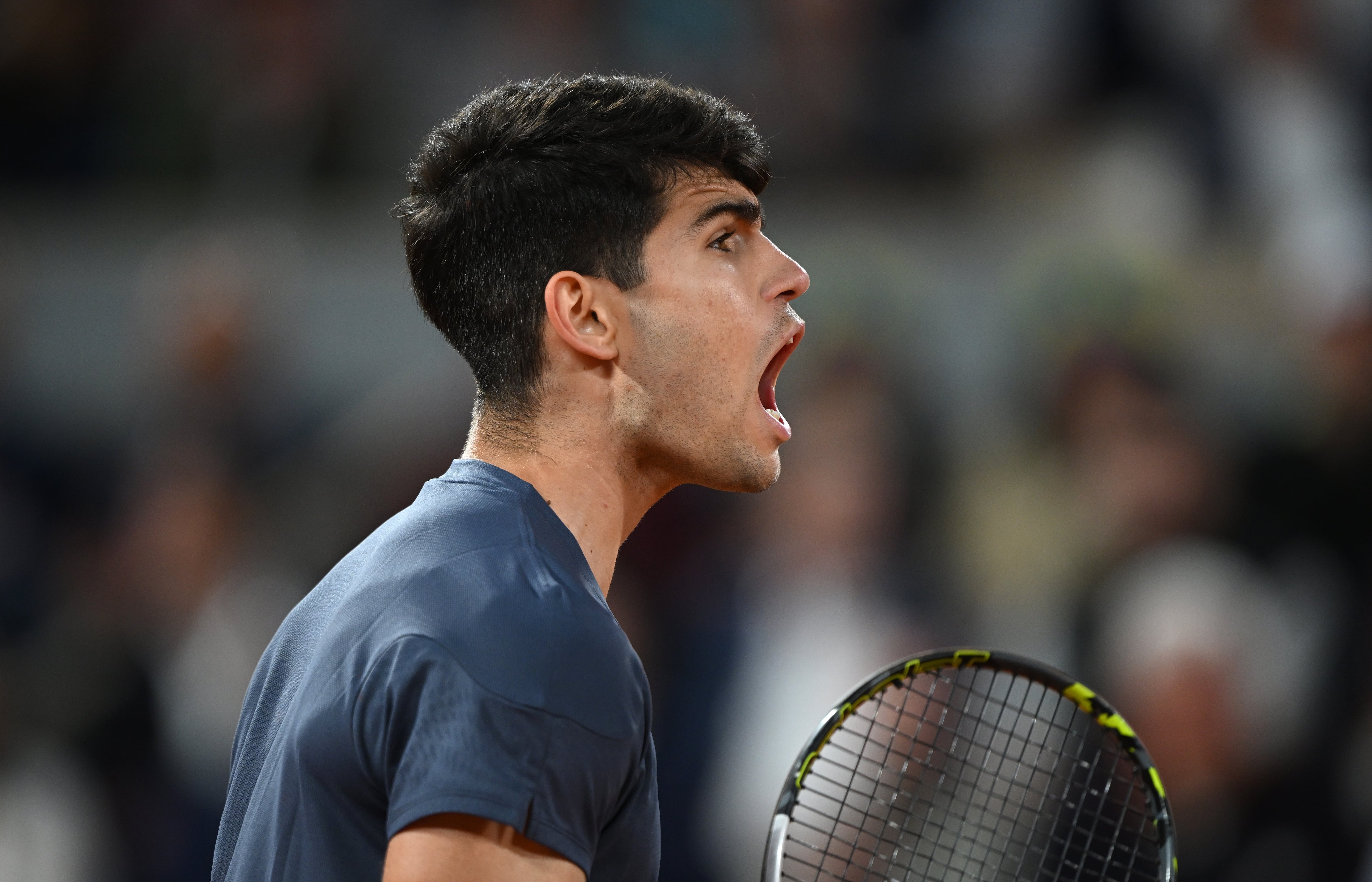 PARIS, FRANCE - JUNE 04: Carlos Alcaraz of Spain celebrates a point against Stefanos Tsitsipas of Greece in the Men&#039;s Singles Quarter Final match during Day Ten of the 2024 French Open at Roland Garros on June 04, 2024 in Paris, France. (Photo by Clive Mason/Getty Images)