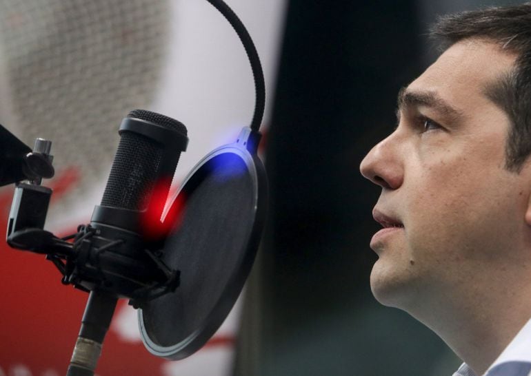 Greek Prime Minister Alexis Tsipras gives an interview at the Sto Kokkino radio station in Athens, July 29, 2015. Tsipras, struggling to contain a revolt in his left-wing Syriza party, said on Wednesday that his government would not implement reform measu