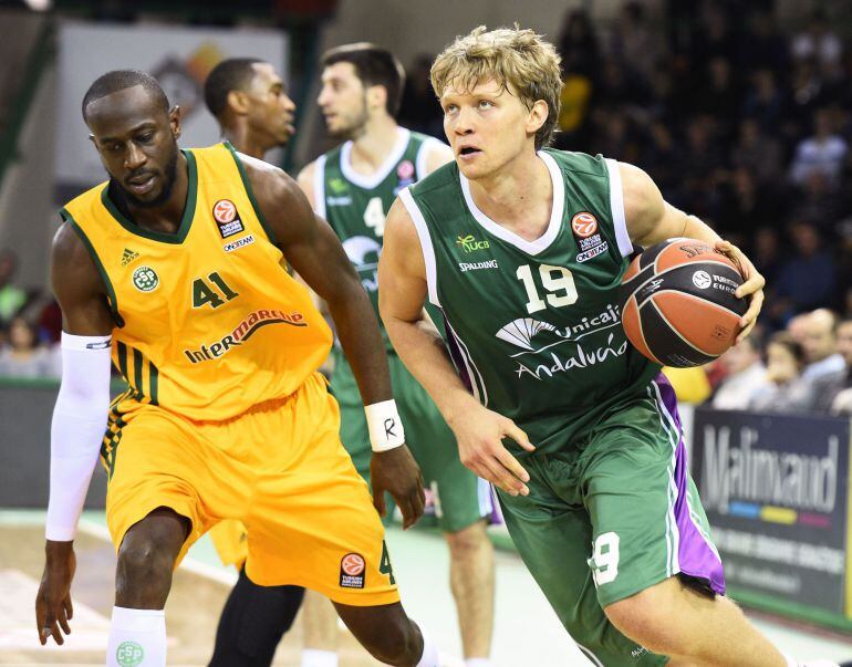 Limoges' Nobel Boungou-Colo (L) vies with Malaga's Mindaugas Kuzminskas, on December 4, 2014 during a Euroleague basketball match Limoges vs Malaga at the Beaublanc stadium in Limoges. AFP PHOTO / PASCAL LACHENAUD