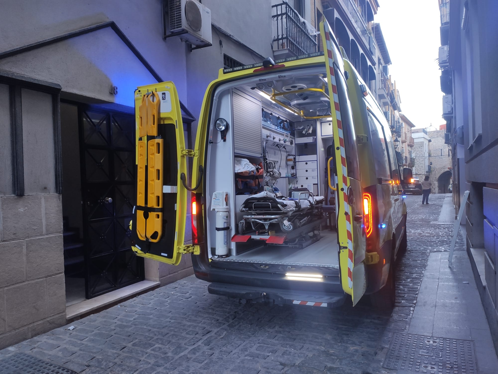 Una ambulancia con las puertas traseras abiertas en la calle Almendros Aguilar de Jaén.