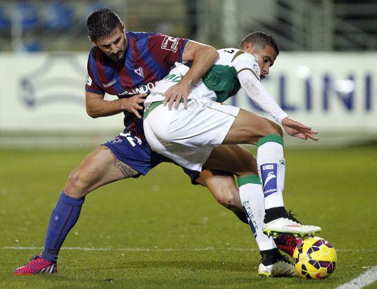 El defensa del Eibar Raúl Navas lucha un balón con el brasileño Jonathas de Jesús, del Elche.