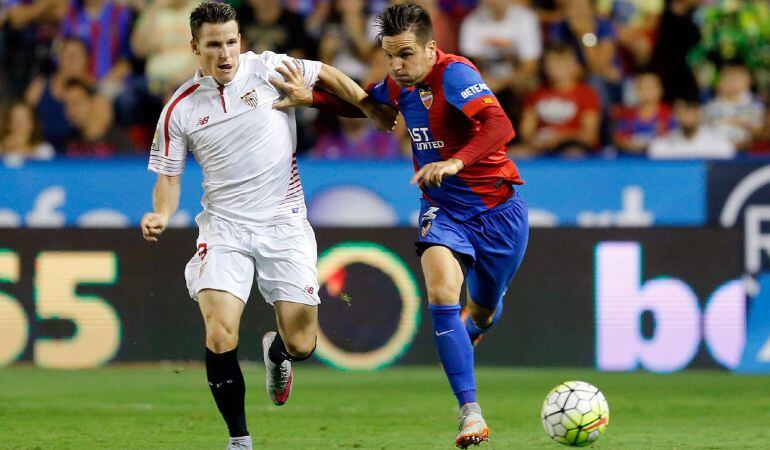 GRA481. VALENCIA, 11/09/2015.- El delantero francés del Sevilla, Kevin Gameiro (i), disputa un balón con el defensa del Levante, Antonio García "Toño", durante el encuentro correspondiente a la tercera jornada de primera división, que disputan esta noche en el estadio Ciutat de Valencia. EFE / Juan Carlos Cárdenas.