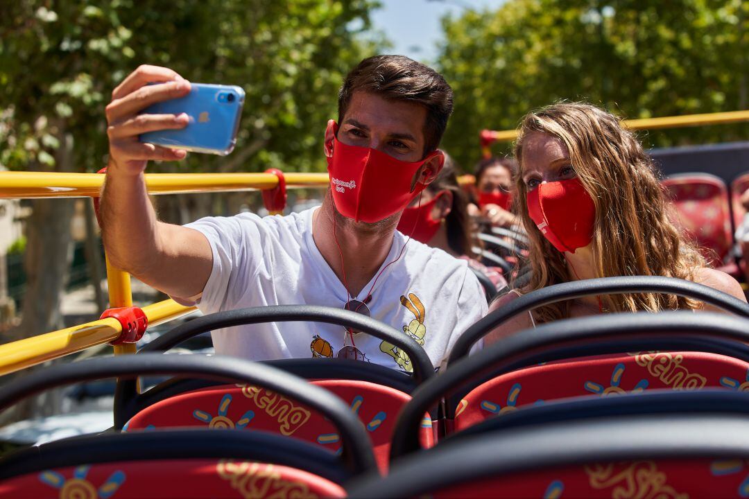Dos jóvenes disfrutan de un tour con mascarillas de City Sightseeing