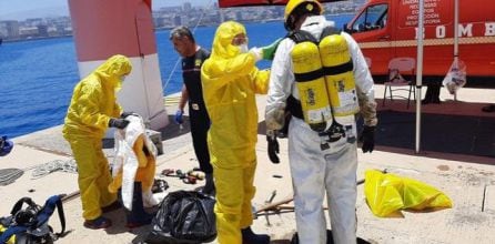 Imagen de agentes de Aduanas y bomberos utilizando equipos de respiración para acceder al interior del buque