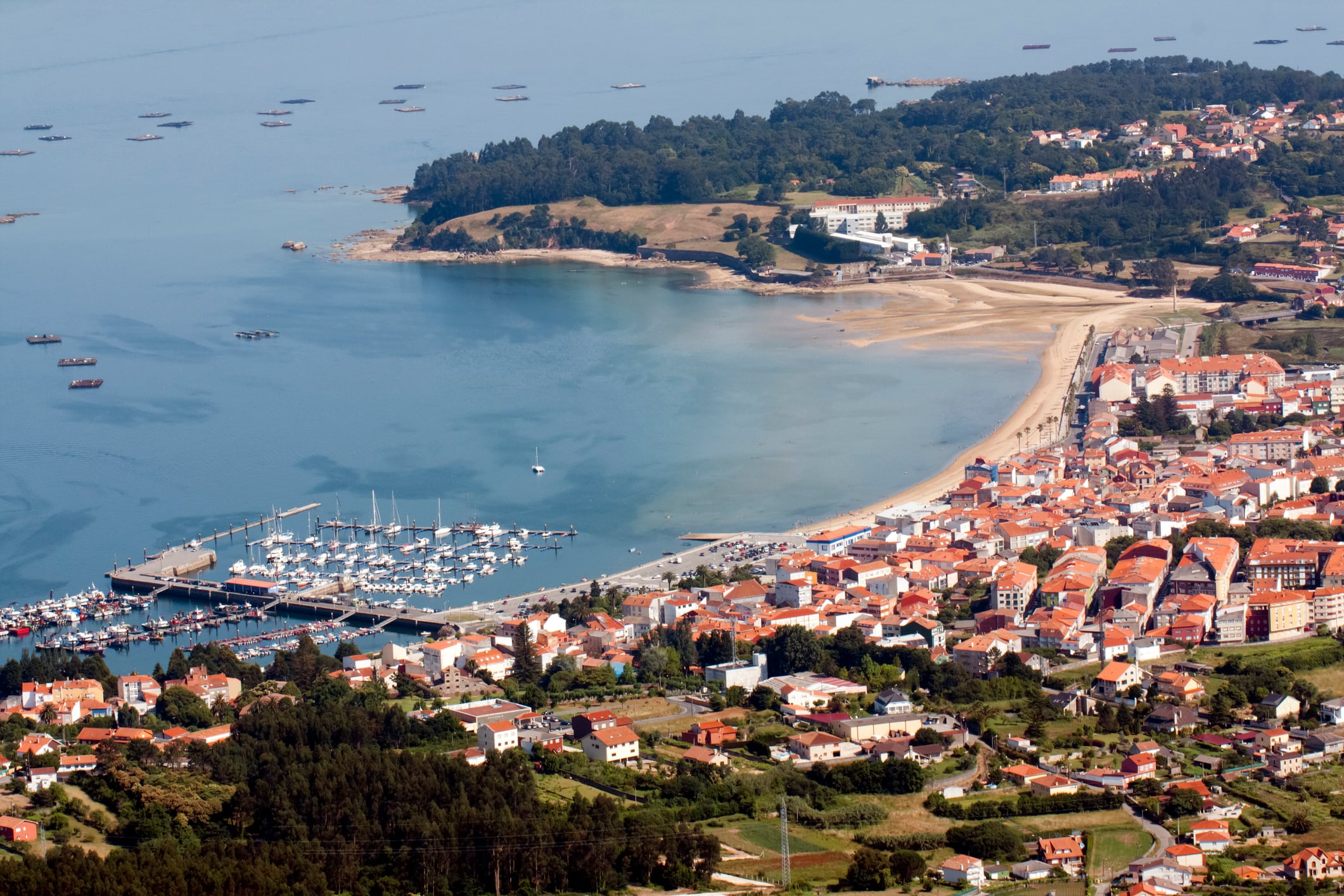 Pobra do Caramiñal, beach and village in Ría de Arousa, Rias Baixas, Pontevedra province, Galicia, Spain. High angle view, seascape.