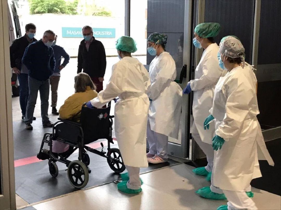 Una de las últiams pacientes sale del Hospital de la Feria ayudado por el personal sanitario. 