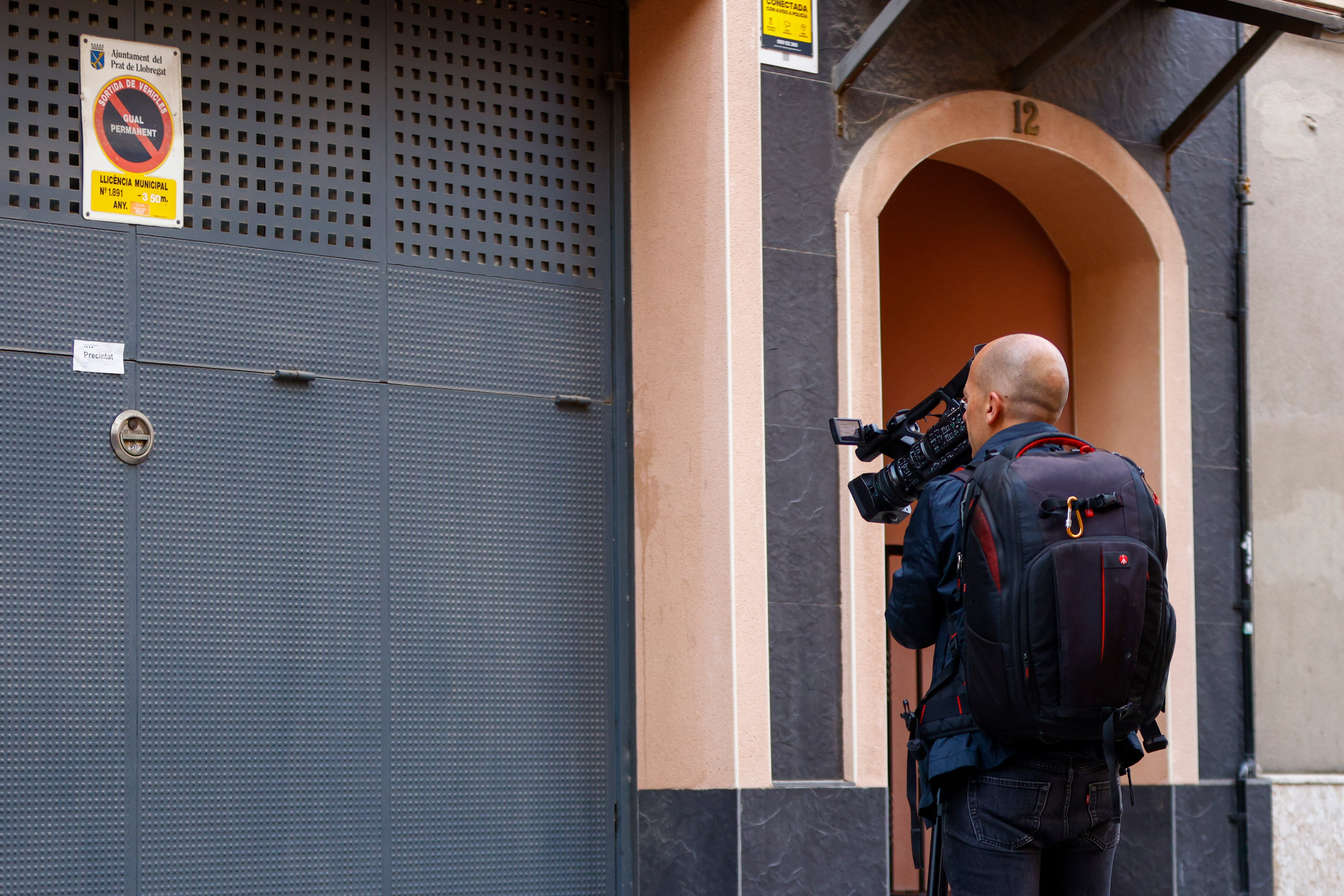 Un operador de TV toma imágenes ante la vivienda donde se produjeron los hechos precintada por la policía.