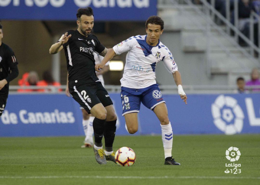 Milla controla el balón ante la presencia de Molinero 