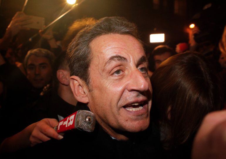 Former French President Nicolas Sarkozy arrives at his headquarters, in Paris, Saturday, Nov. 29, 2014. Sarkozy had been widely expected to win the Union for a Popular Movement leadership in the vote by party members Saturday. The 59-year-old Gaullist col