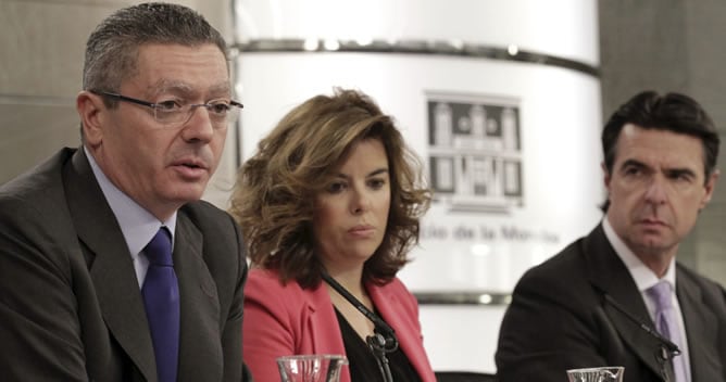 El ministro de Justicia, Alberto Ruiz-Gallardón; la vicepresidenta del Gobierno, Soraya Sáenz de Santamaría; y el ministro de Industria, Energía y Turismo, José Manuel Soria, durante la rueda de prensa tras el Consejo de Ministros.