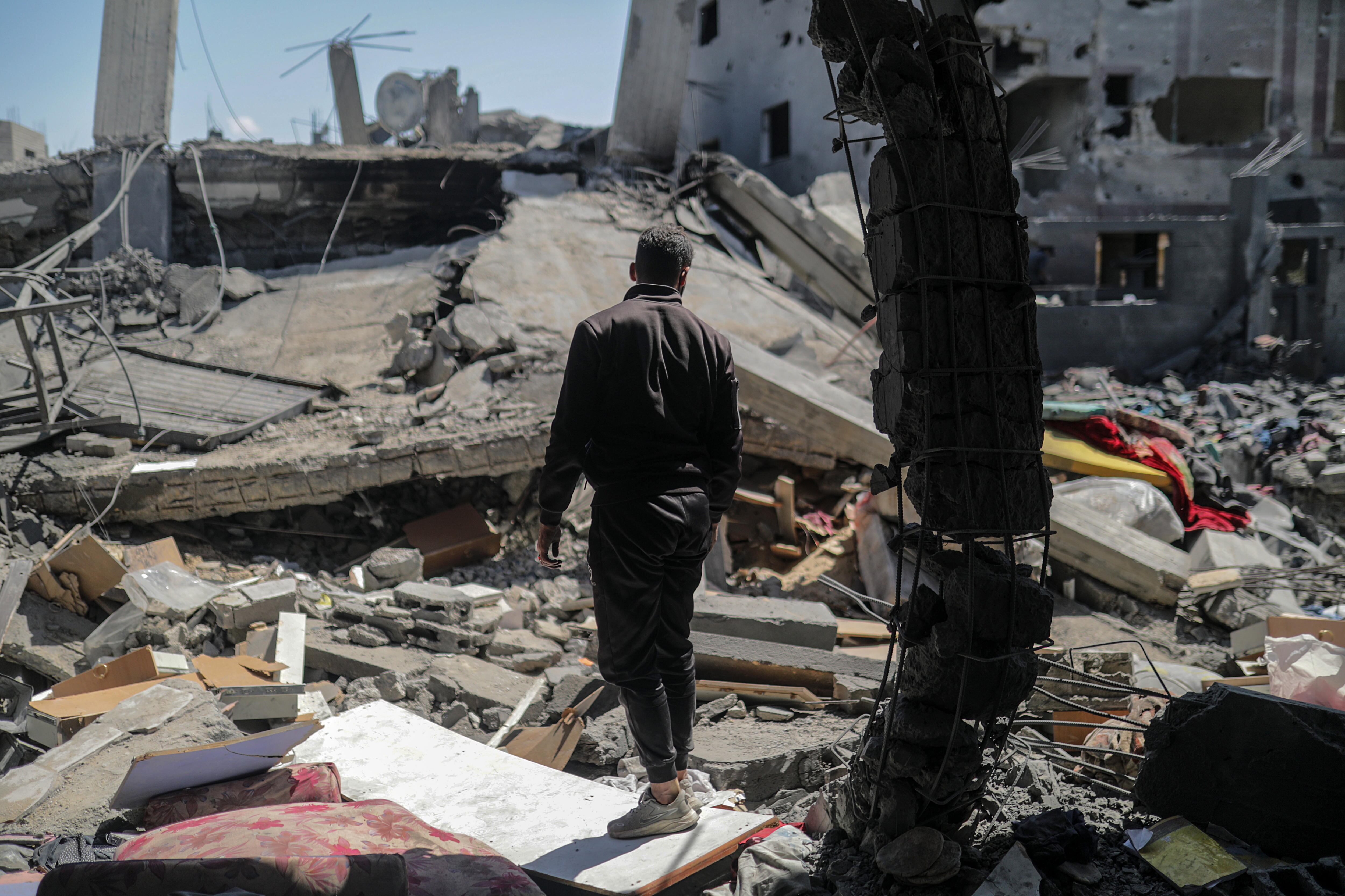 Palestinians search for the missing following an Israeli strike at Al Nusairat refugee camp