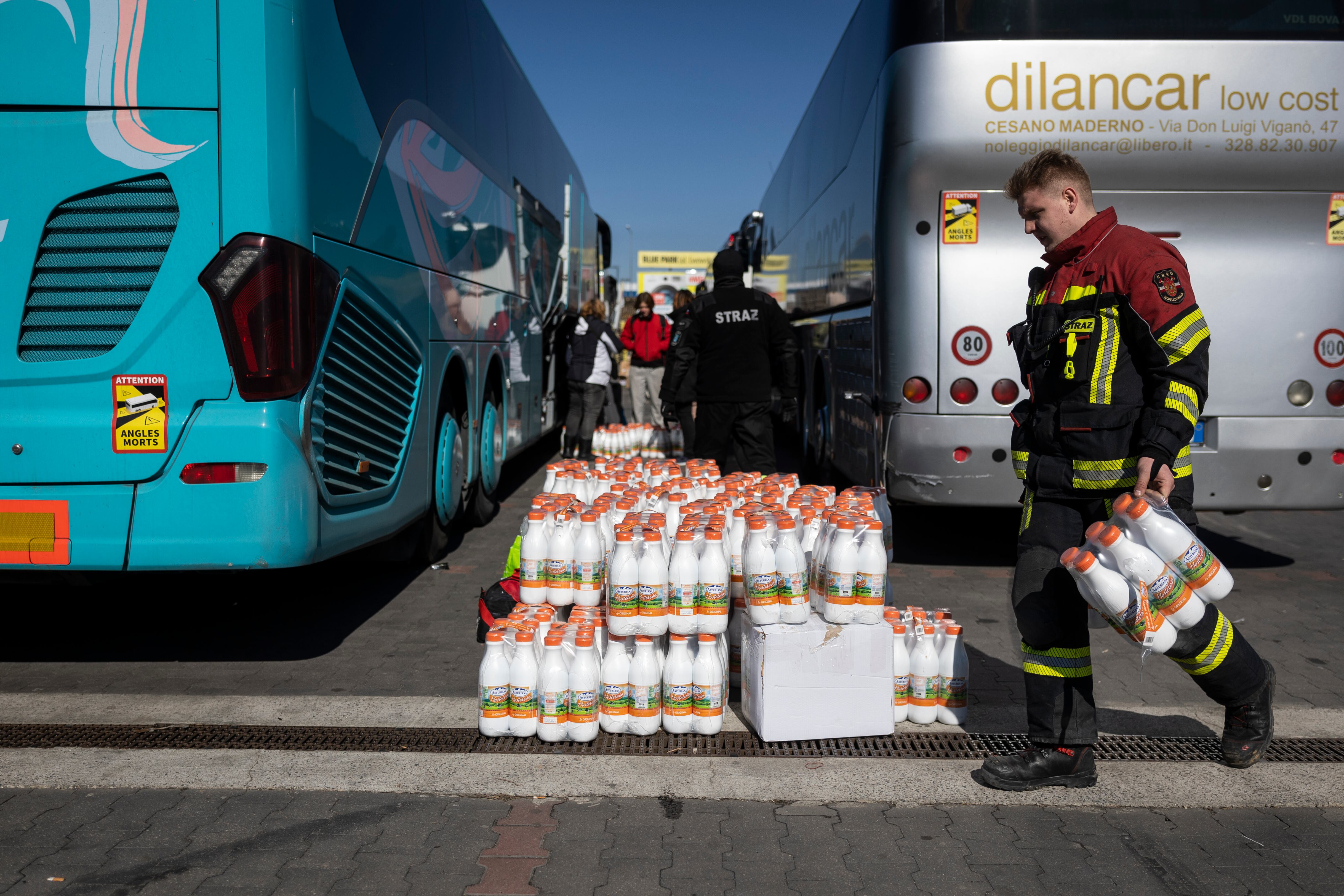 Un voluntario cargan con comida y material los autobuses fletados por la ONG Unidos por la Libertad con destino a València.