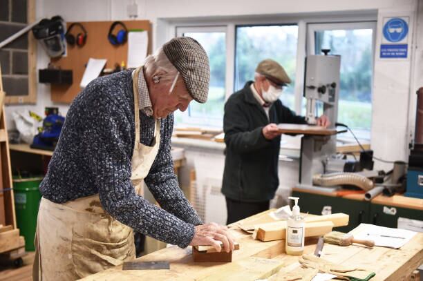 YORK, ENGLAND - DECEMBER 14: Members from Yorks Men's Shed attend their weekly meeting as they work on joinery projects on December 14, 2021 in York, England. The Men's Shed concept began in Australia in the mid-1990s and provides a safe and inclusive space for retired men to come together and socialise and work on projects together. The idea is to negate the health and well-being issues that can plague retired men due to social isolation. (Photo by Nathan Stirk/Getty Images)