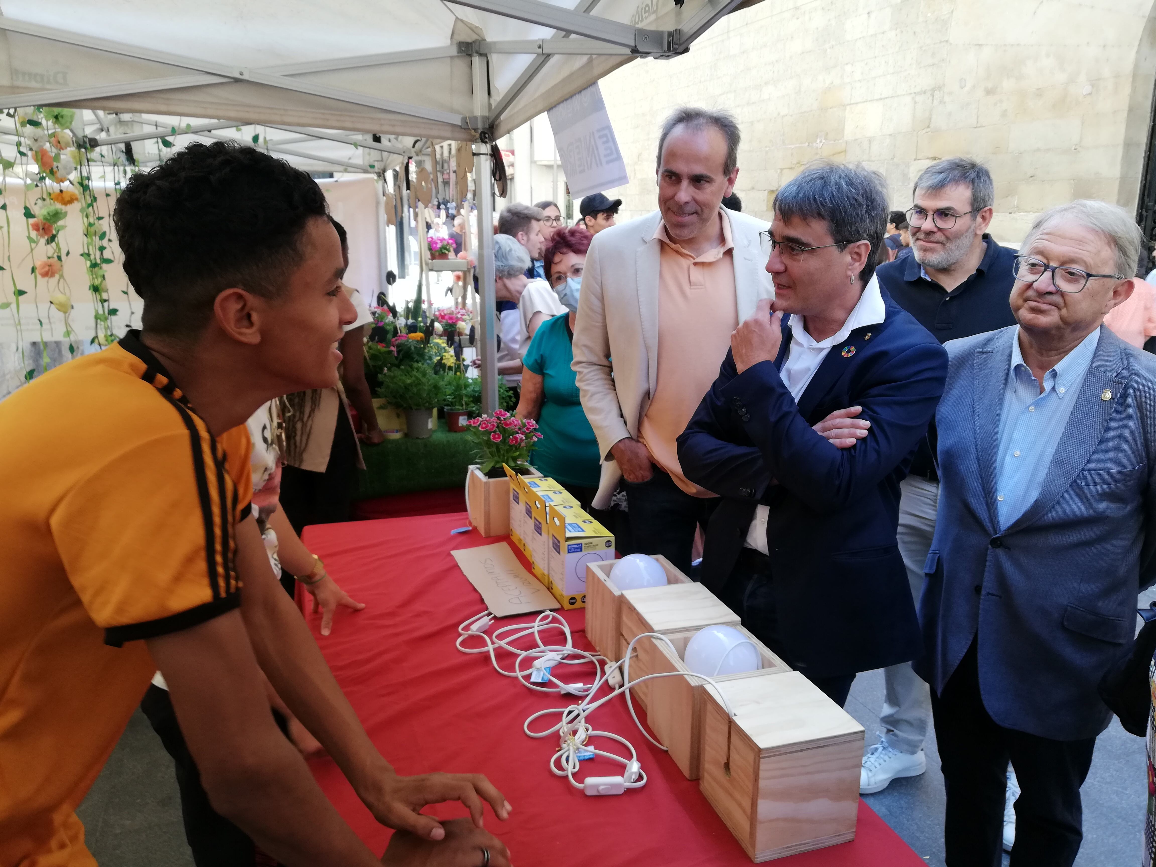 Carles Gibert, Paco Cerdà i David Melé, entre altres autoritats, conversant amb dos dels joves participants en el mercadet dels joves empresaris de Ponent que s'ha fet avui. Foto: Ràdio Lleida.