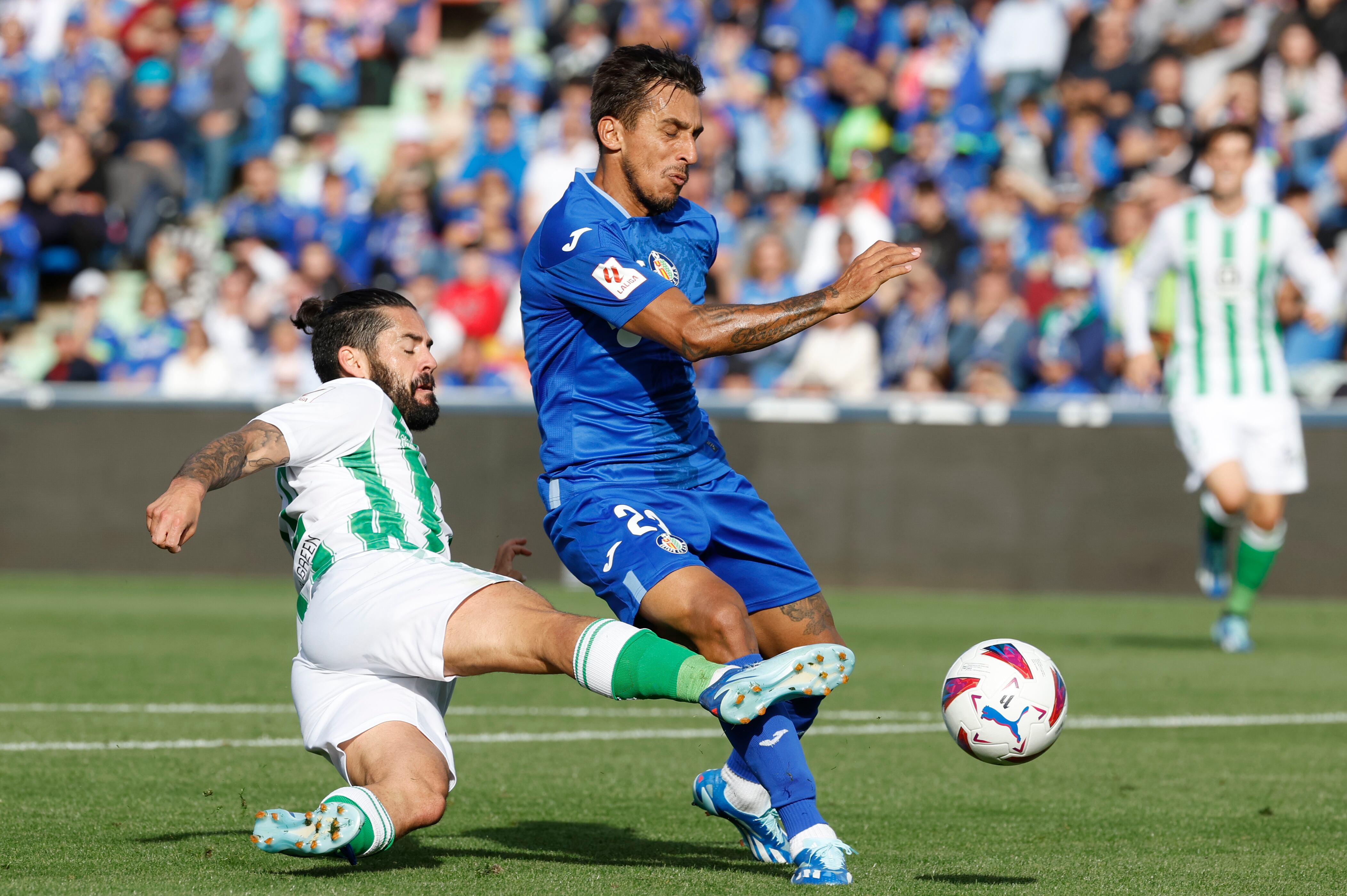 GETAFE (MADRID), 21/10/2023.- Isco, centrocampista del Real Betis (i) disputa una posesión ante Stefan Mitrovic, defensa serbio del Getafe SAD durante el partido de LaLiga entre el Getafe y el Betis, este sábado en el Coliseum. EFE/ Mariscal
