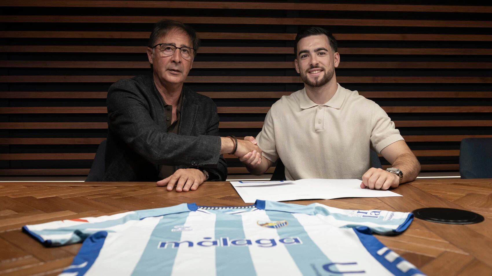 El centrocampista del Málaga Ramón Enríquez y el director deportivo Loren Juarros, en el momento de la firma del nuevo contrato del jugador por dos temporadas