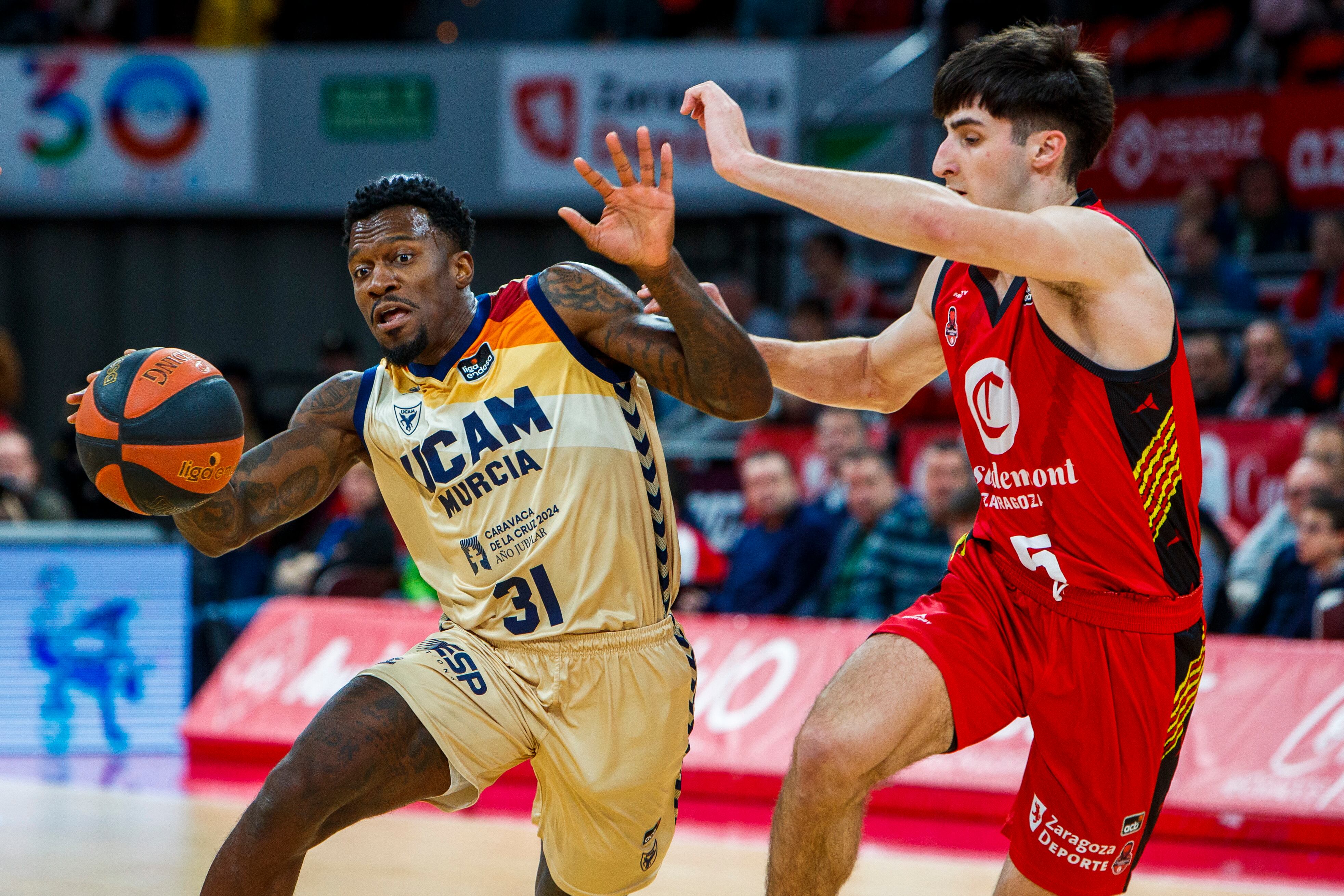 GRAF7135. ZARAGOZA, 02/12/2023.- El jugador del UCAM Murcia Dylan Ennis (i) ante Lucas Langarica, del Casademont Zaragoza, durante un encuentro correspondiente a la liga ACB en Zaragoza. EFE/ Javier Belver
