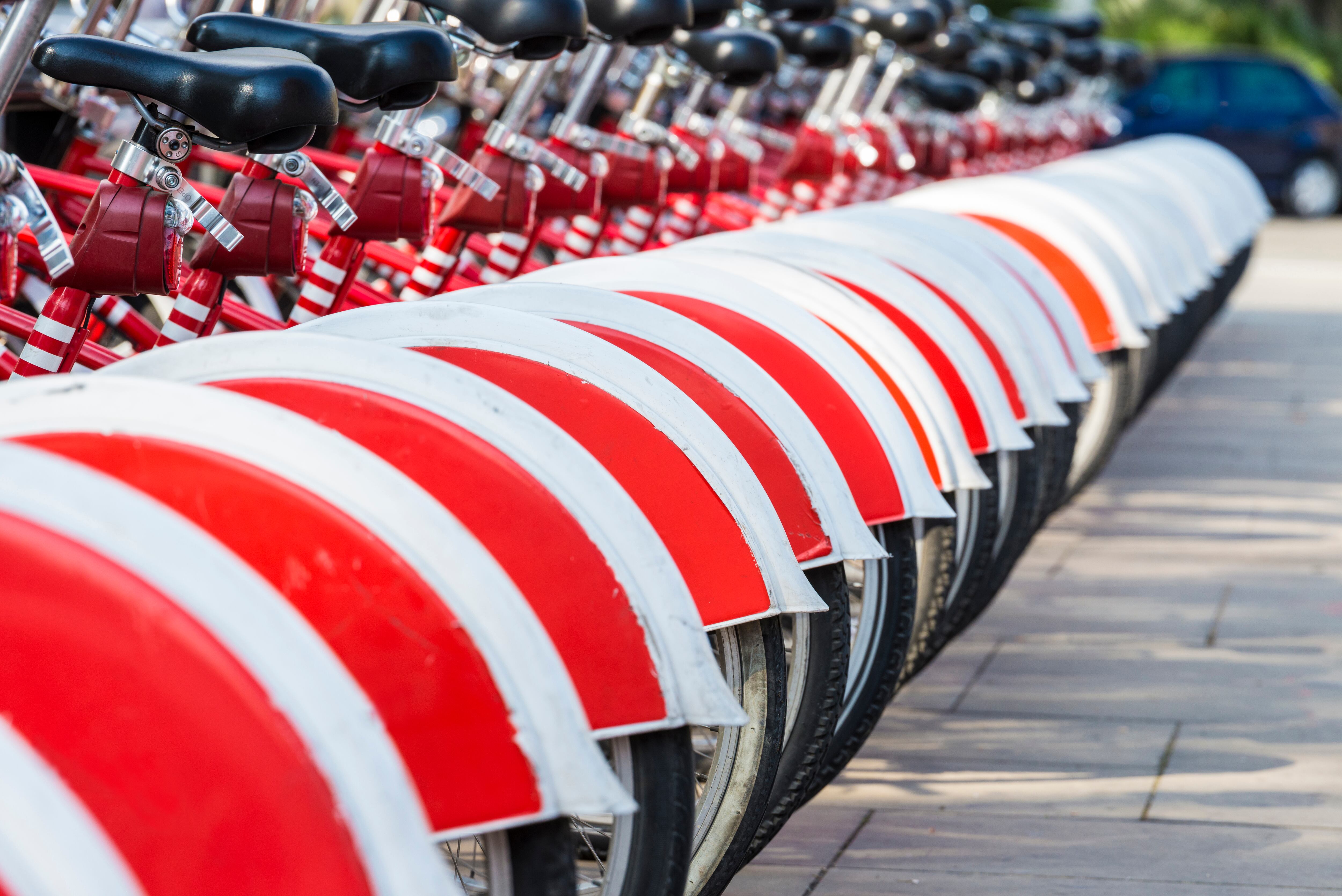 A row of rental bikes in their docking stands in downtown Barcelona, Catalonia, Spain