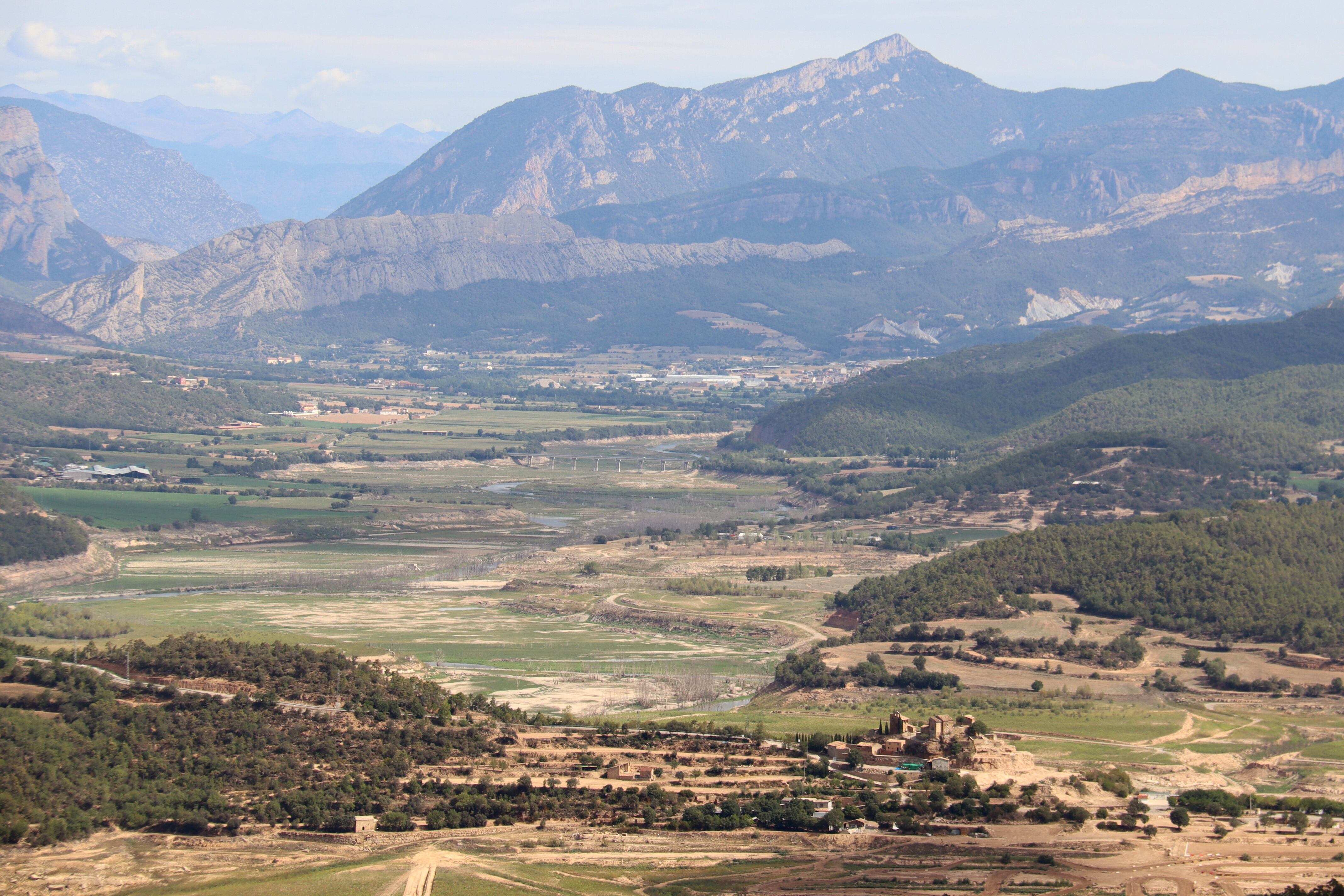 Panoràmica de la cua del pantà de Rialb des del nucli de Mirambell, a Bassella (Alt Urgell), on es veu el nucli de la Clua i la poca aigua que hi ha acumulada a la zona