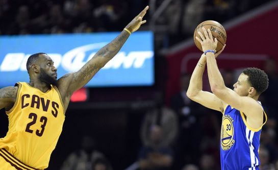 Jun 9, 2015; Cleveland, OH, USA; Golden State Warriors guard Stephen Curry (30) shoots the ball over Cleveland Cavaliers forward LeBron James (23) during the fourth quarter in game three of the NBA Finals at Quicken Loans Arena. Mandatory Credit: Bob Donn