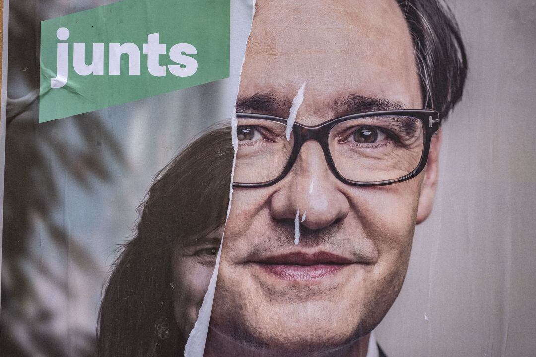  An electoral poster of the independence candidate, Laura Borràs is seen on La Rambla covered by another of the socialist candidate, Salvador Illa 