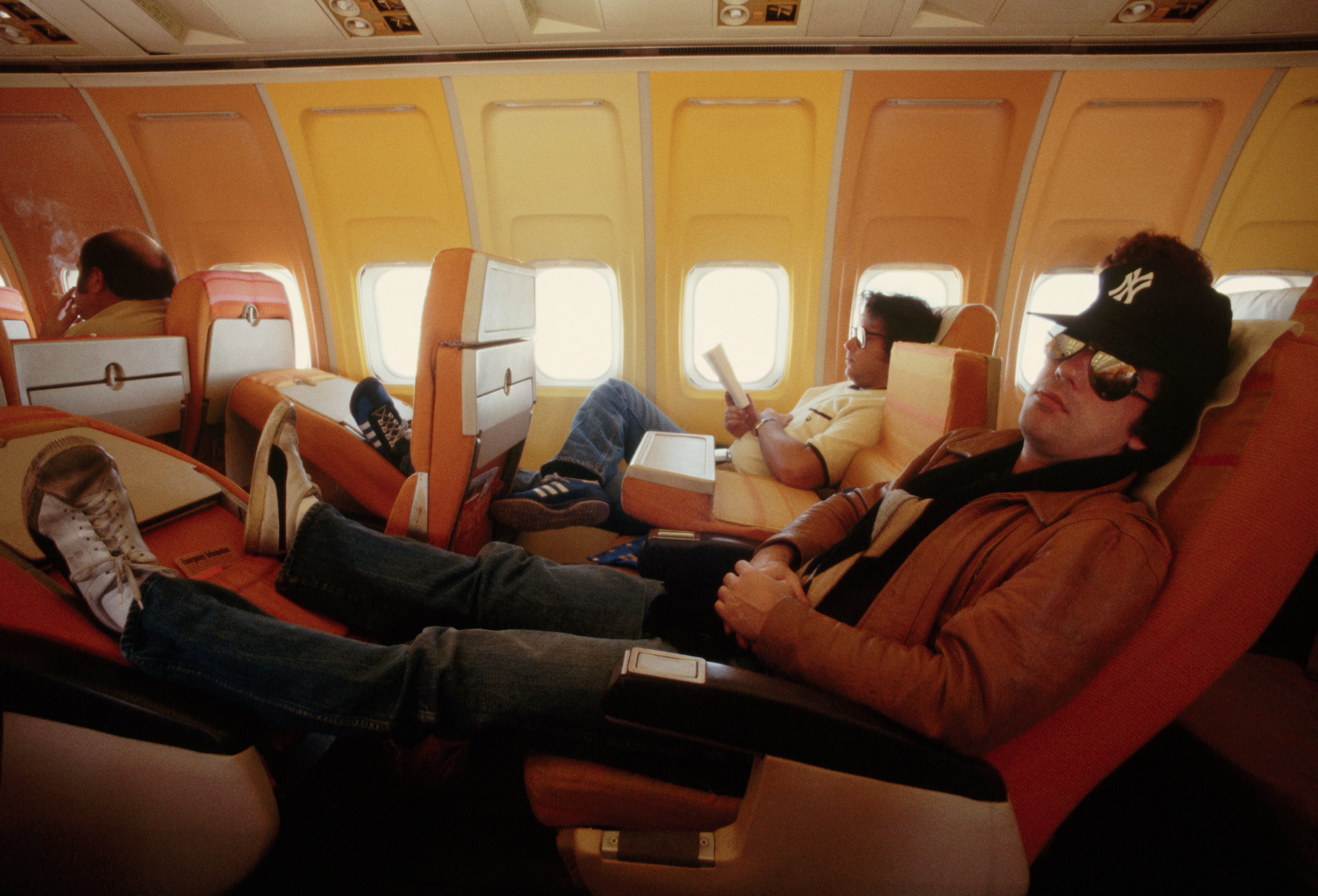 Singer and pianist Billy Joel rests on an airline flight between Austin and Dallas during a tour promoting his &quot;57th Street&quot; album. | Location: Above Texas, USA.  (Photo by © Wally McNamee/CORBIS/Corbis via Getty Images)