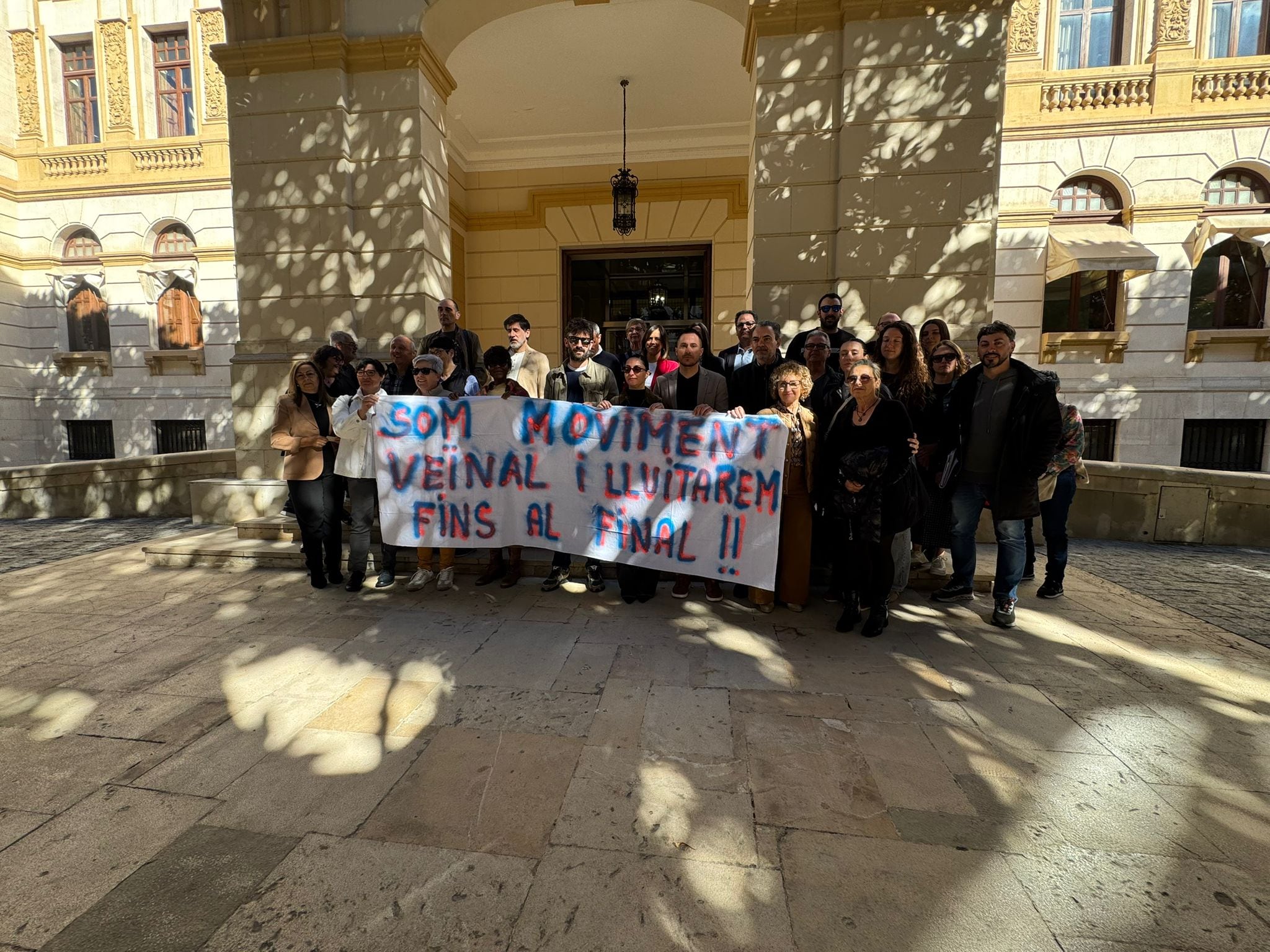El grupo de vecinos de L'Alqueria d'Asnar con una pancarta de protesta a las puertas del Palacio Provincial