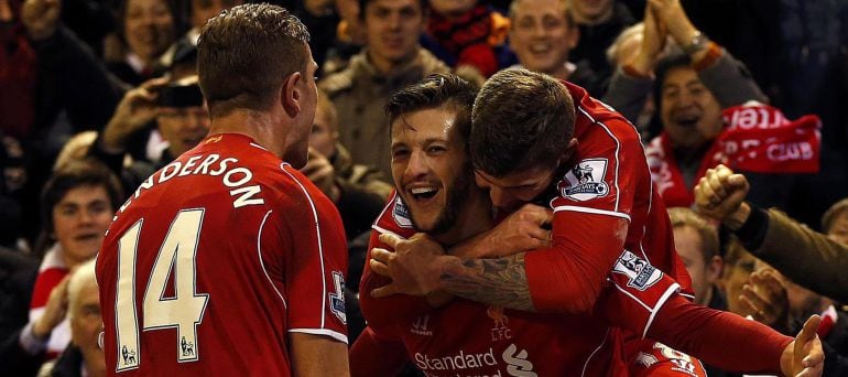 Liverpool&#039;s Adam Lallana (C) celebrates his second goal against Swansea City with Alberto Moreno (R) and Jordan Henderson during their English Premier League soccer match at Anfield in Liverpool, northern England December 29, 2014.      REUTERS/Phil Noble