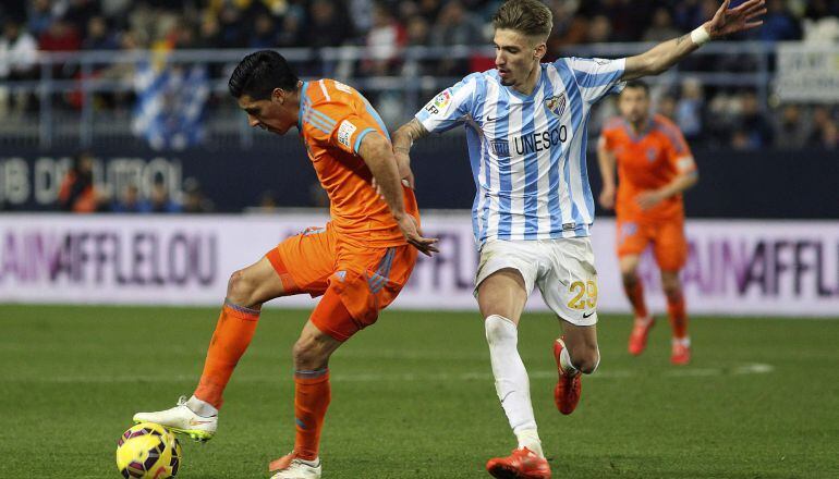 El centrocampista argentino del Valencia CF Enzo Pérez controla el balón ante la presión de Samuel Castillejo