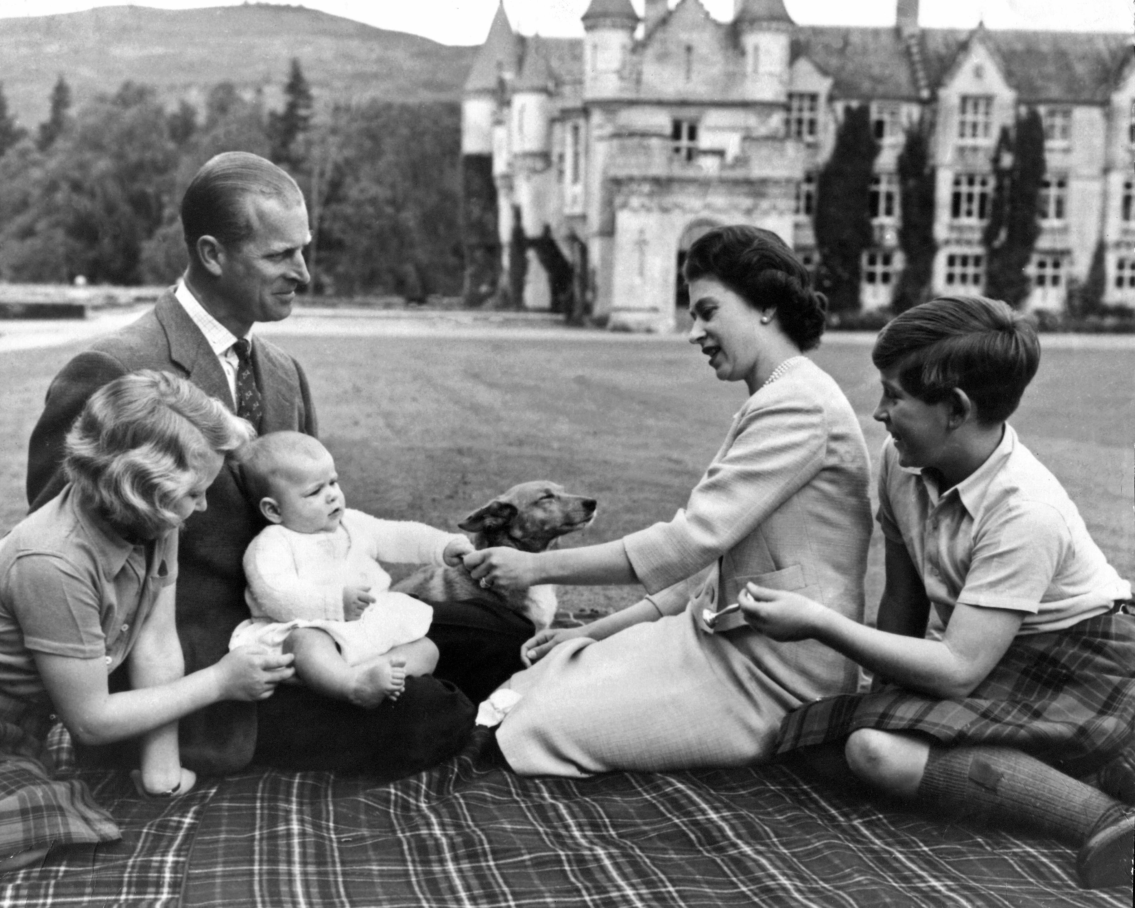 La reina Isabel II junto a su marido, el duque de Edimburgo, y sus hijos Carlos, Ana y Andrés en el Castillo de Balmoral de Escocia junto a un perro corgis.