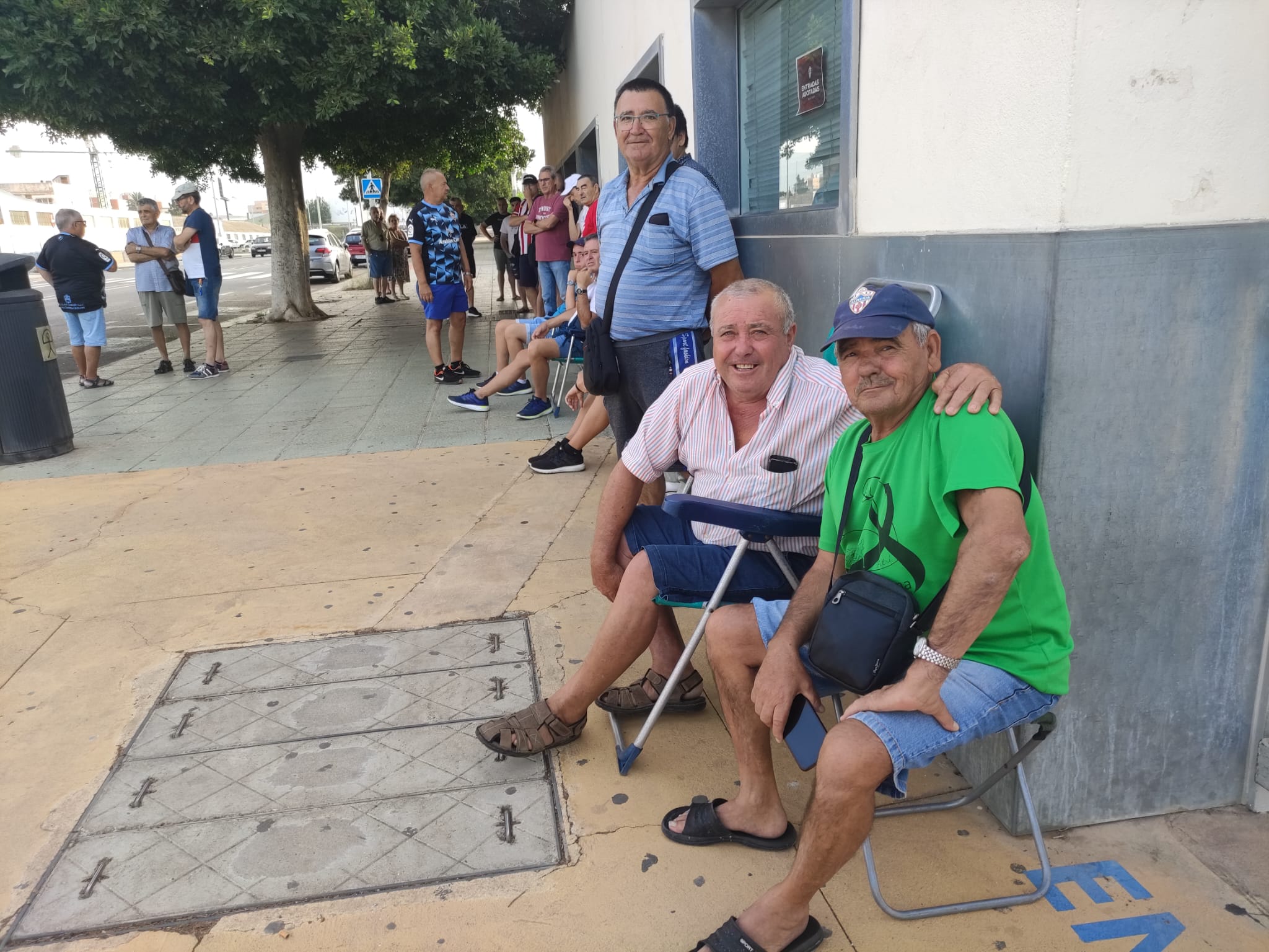 Los seguidores aguantan las colas y el calor con el mejor humor.