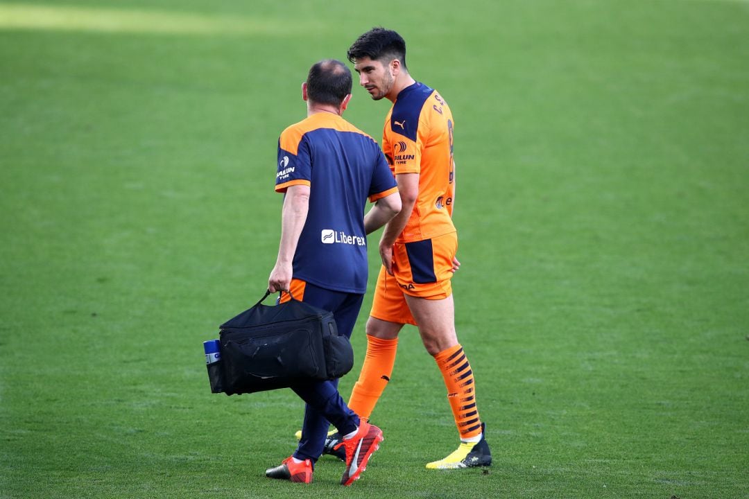 Carlos Soler of Valencia CF receives medical treatment as he is substituted off during the La Liga Santander match between Real Betis and Valencia CF at Estadio Benito Villamarin on April 18, 2021 in Seville, Spain. Sporting stadiums around Spain remain u